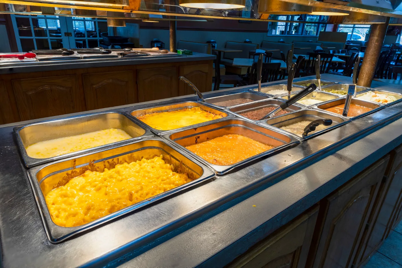 Hot Southern buffet line with baked mac and cheese, squash casserole, and pinto beans