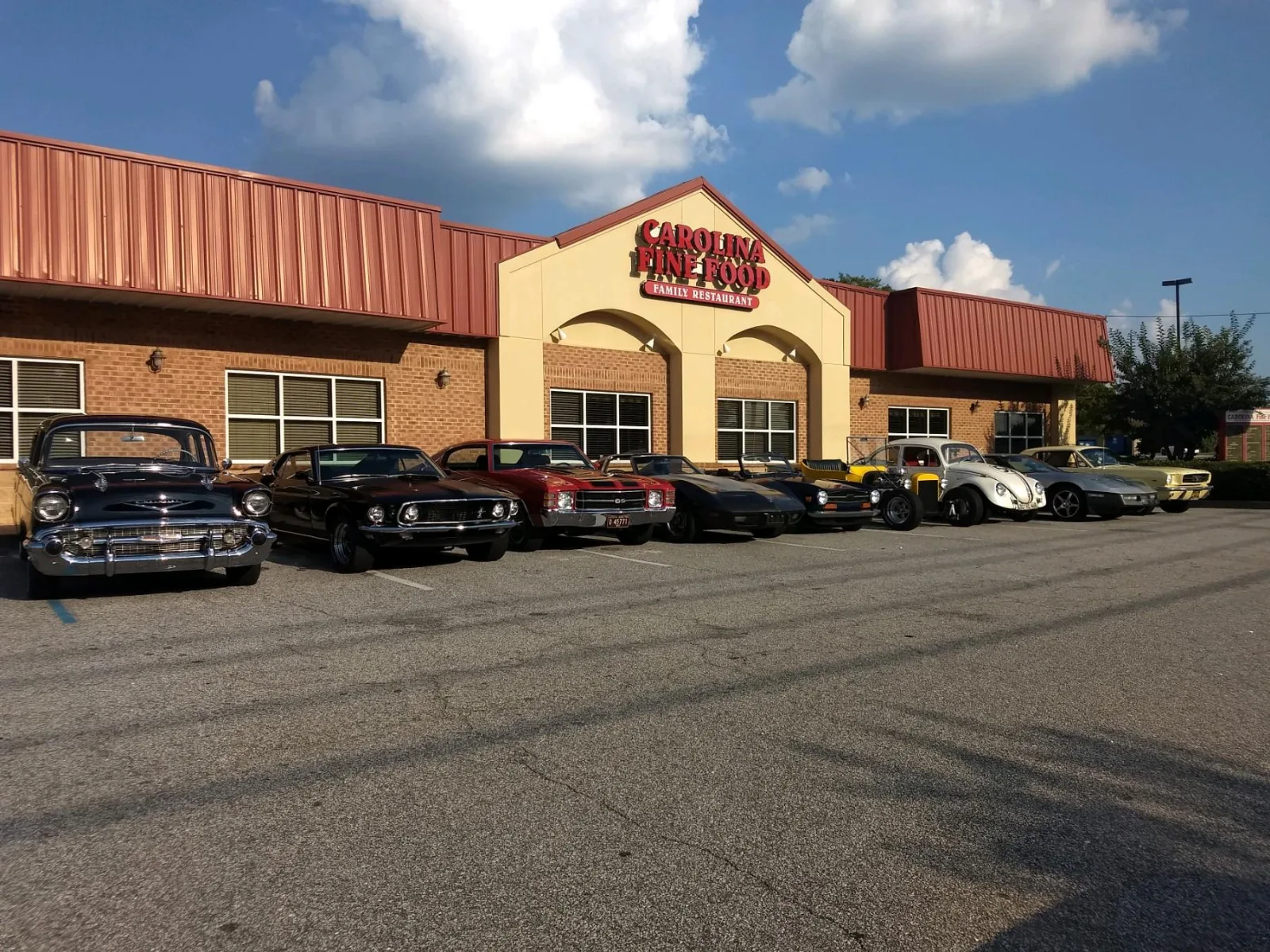 Carolina Fine Foods storefront on SE Main Street in Simpsonville, SC, with classic cars parked out front